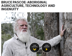 Older man with white hair and beard, wearing a light grey shirt, stands touching a tree. Text reads "Aboriginal Agriculture, Technology and Ingenuity."
