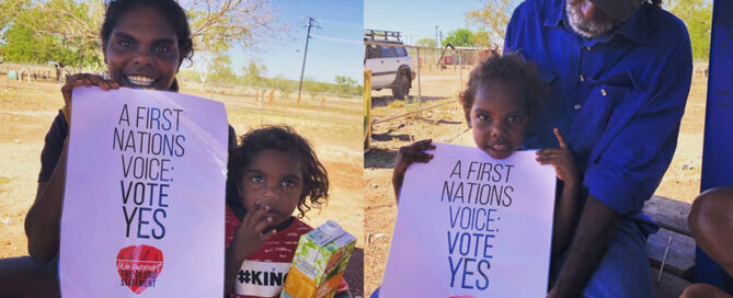 Two images of Indigenous Australian individuals holding a "Vote Yes" poster. They are outdoors with clear skies and dry landscape, conveying a hopeful message.