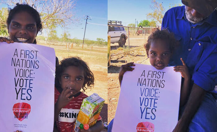 Two images of Indigenous Australian individuals holding a "Vote Yes" poster. They are outdoors with clear skies and dry landscape, conveying a hopeful message.