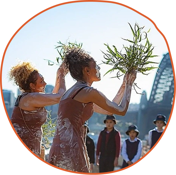 Icon of a person reading to three others, with stars above. Conveys learning, teaching, and inspiration.